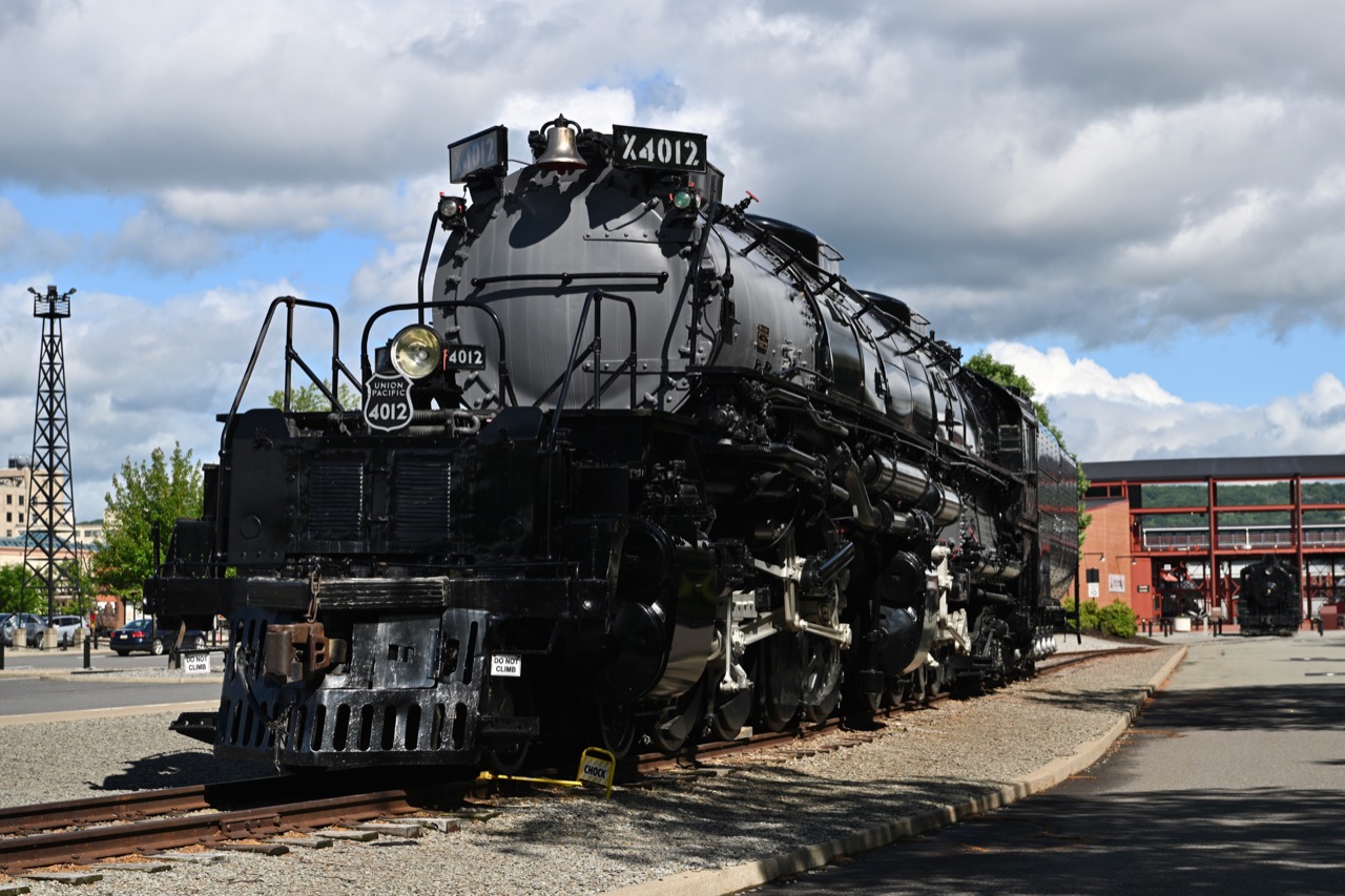 Union Pacific steam locomotive 4012 on display beneath a cloudy sky.